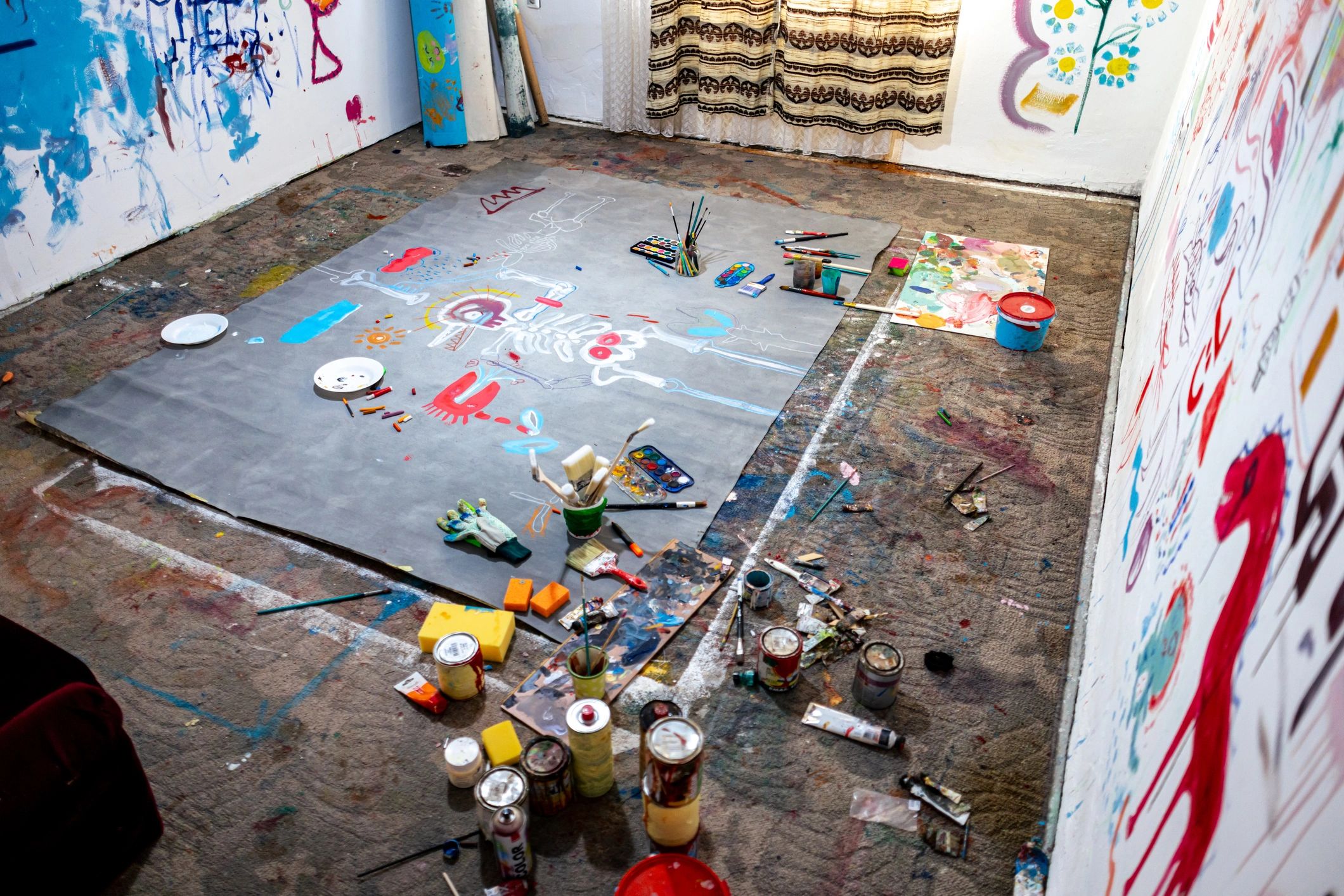 Colorful art studio with large canvas and creative supplies